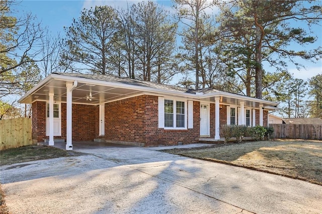 ranch-style home featuring a front lawn and a carport