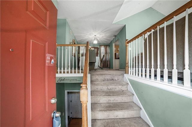 staircase with lofted ceiling