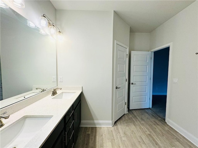 bathroom with hardwood / wood-style flooring and vanity