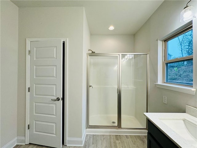 bathroom with vanity, hardwood / wood-style flooring, and an enclosed shower