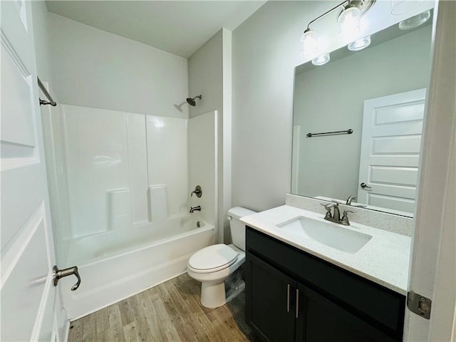 full bathroom featuring hardwood / wood-style floors, vanity, toilet, and shower / tub combination