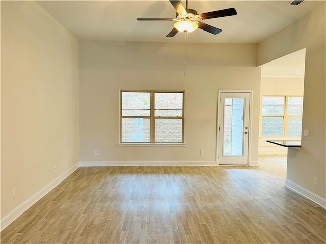 empty room with light hardwood / wood-style flooring and ceiling fan