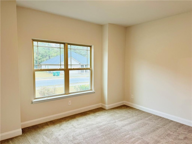 empty room featuring light carpet