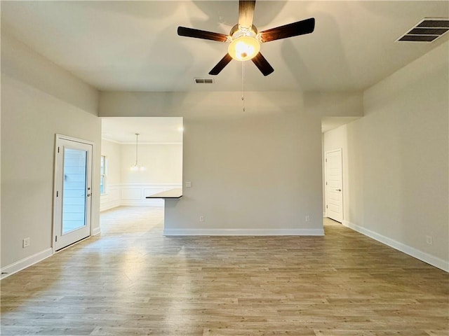 empty room with ceiling fan and light hardwood / wood-style flooring