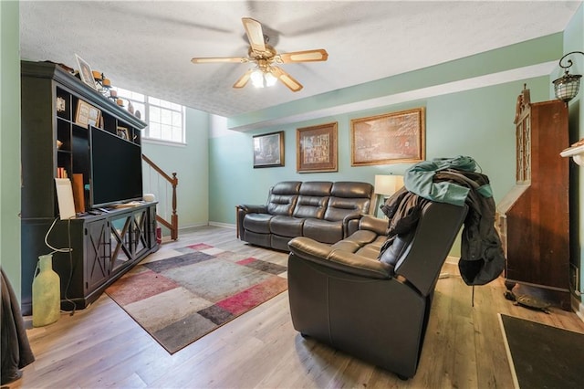 3620 Darwin Pl, Duluth, GA 30096 - living room featuring wood finished floors, stairs, a ceiling fan, and a textured ceiling