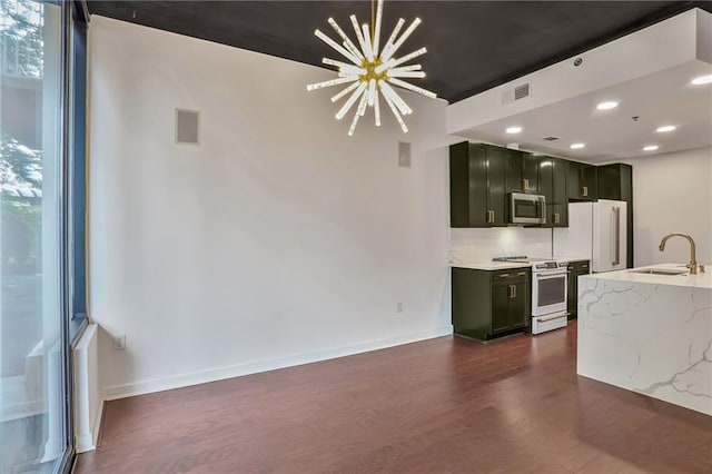 855 Peachtree St NE Unit 1108, Atlanta, GA 30308 - kitchen with white appliances, a chandelier, dark wood-style flooring, dark cabinets, and light stone countertops