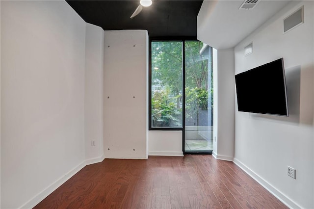 855 Peachtree St NE Unit 1108, Atlanta, GA 30308 - spare room with floor to ceiling windows, wood finished floors, and a ceiling fan
