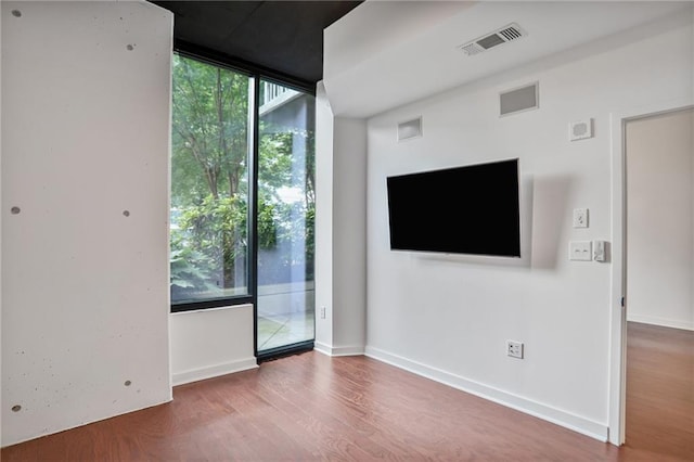 855 Peachtree St NE Unit 1108, Atlanta, GA 30308 - unfurnished living room with wood finished floors and floor to ceiling windows