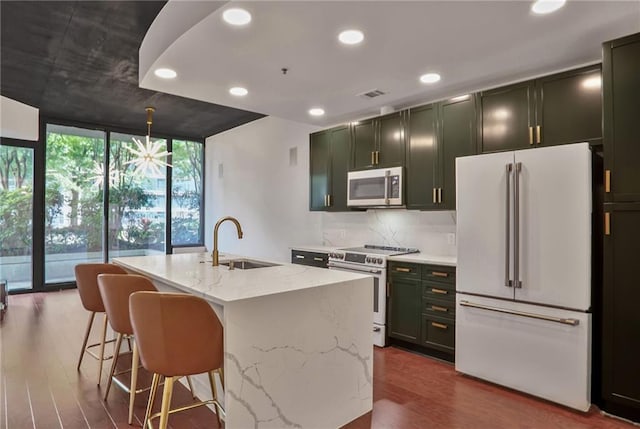 855 Peachtree St NE Unit 1108, Atlanta, GA 30308 - kitchen featuring white appliances, a wall of windows, light stone countertops, dark wood-style floors, and recessed lighting