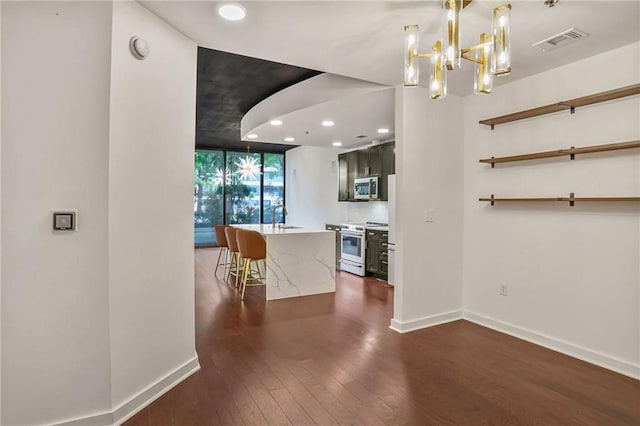 855 Peachtree St NE Unit 1108, Atlanta, GA 30308 - kitchen with appliances with stainless steel finishes, dark wood-style floors, recessed lighting, light countertops, and a chandelier