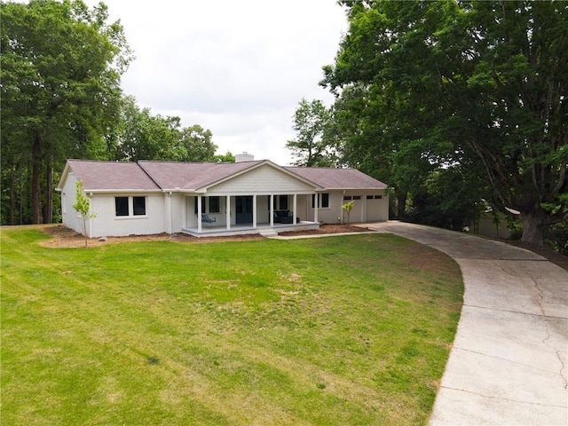 ranch-style home with a front yard, a garage, and covered porch