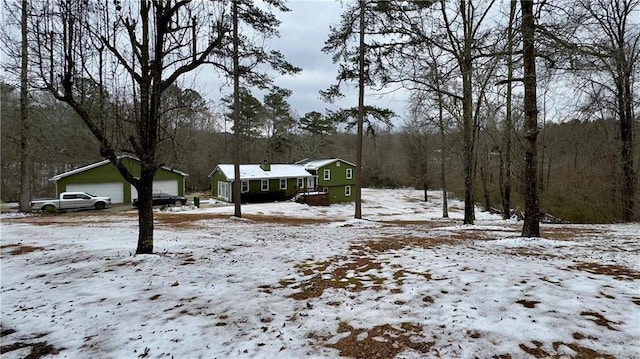 yard covered in snow featuring a garage