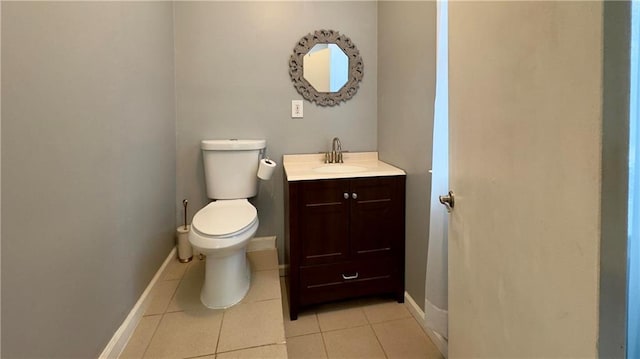 bathroom with tile patterned floors, vanity, and toilet