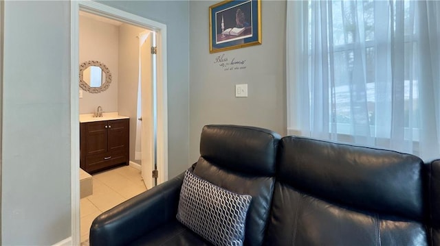 living area with sink and light tile patterned floors