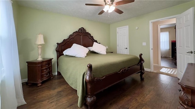 bedroom with ceiling fan and dark hardwood / wood-style floors