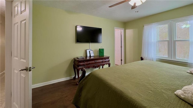 bedroom featuring ceiling fan and dark hardwood / wood-style floors