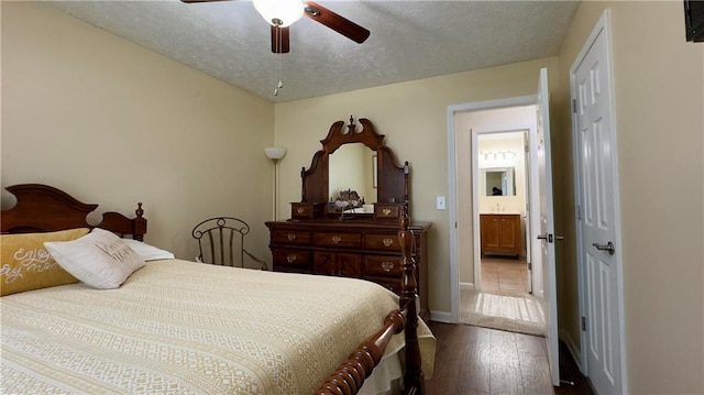 bedroom with a textured ceiling, hardwood / wood-style flooring, ensuite bath, and ceiling fan