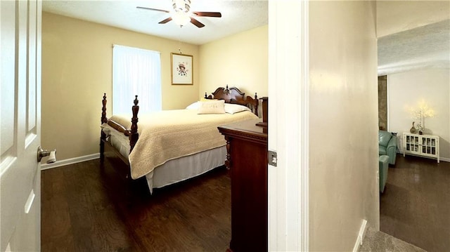 bedroom featuring ceiling fan and dark wood-type flooring