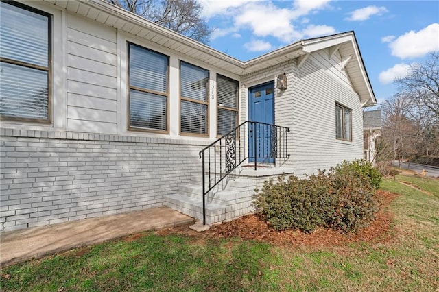 doorway to property with a yard