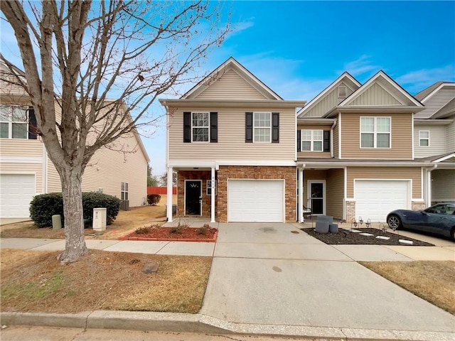 view of property with an attached garage, board and batten siding, and driveway