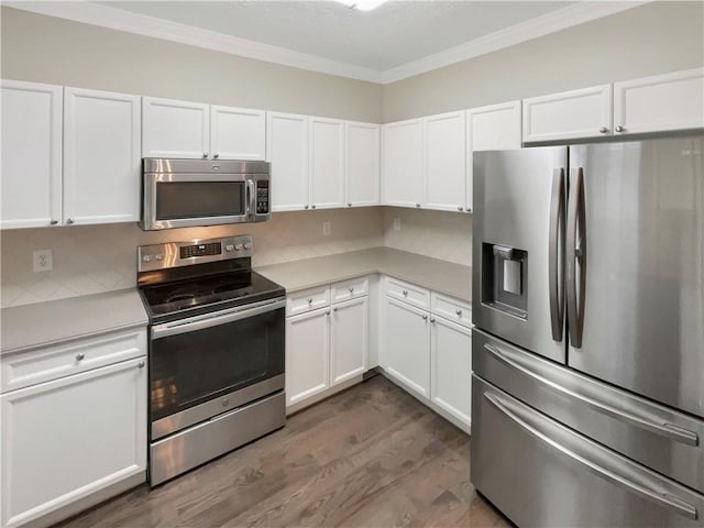 kitchen with white cabinetry, light countertops, and stainless steel appliances