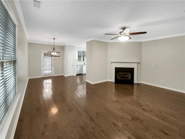 unfurnished living room with visible vents, crown molding, a fireplace with flush hearth, ceiling fan with notable chandelier, and wood finished floors