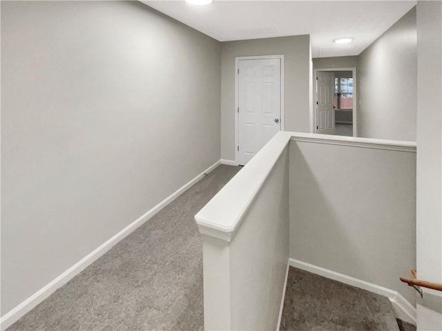 hall with carpet flooring and baseboards