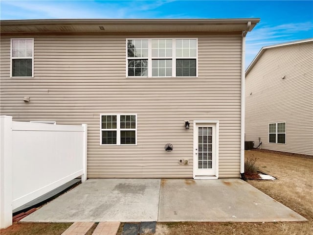 back of property featuring fence, central AC, and a patio area