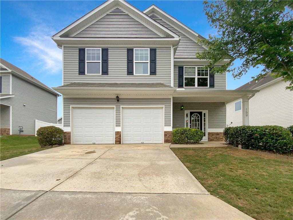 view of front of property with a garage and a front lawn