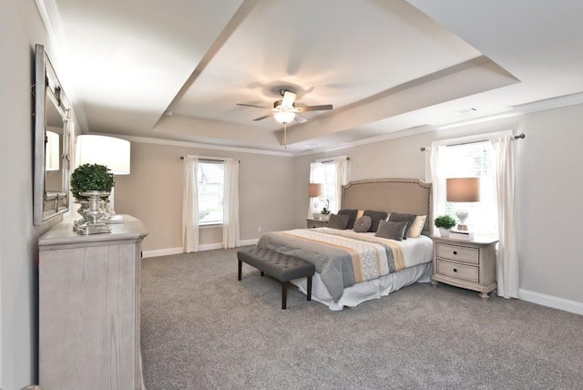 carpeted bedroom with crown molding, a raised ceiling, a ceiling fan, and baseboards