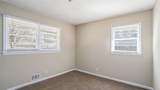 empty room featuring carpet floors