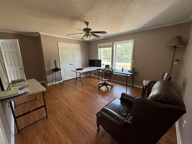 home office with hardwood / wood-style flooring, ceiling fan, a textured ceiling, and crown molding