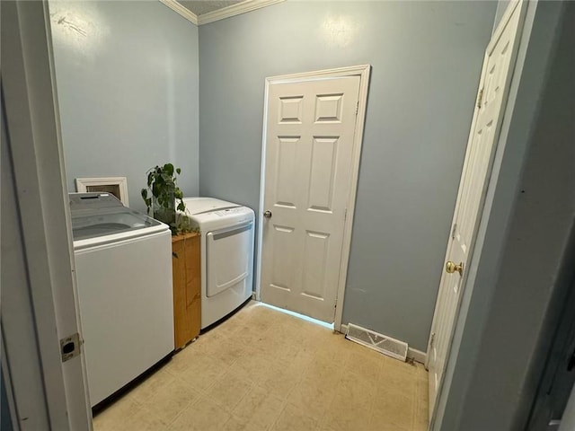 laundry area featuring separate washer and dryer and crown molding