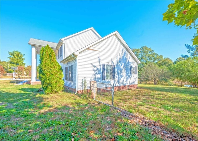 view of side of home featuring a yard