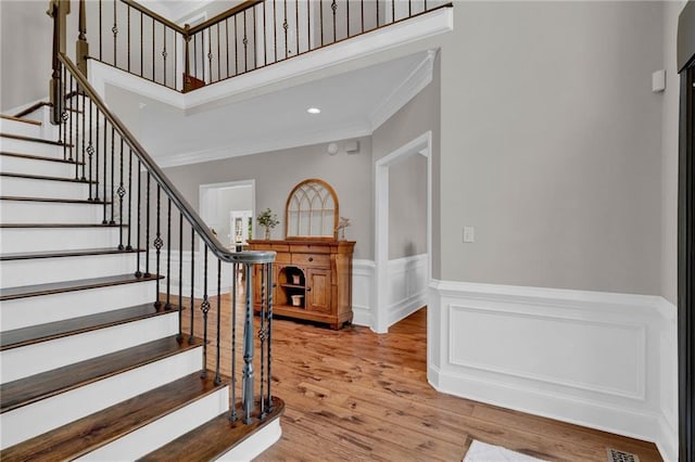 1313 Fallsbrook Ter NW, Acworth, GA 30101 - staircase with ornamental molding, wainscoting, wood finished floors, and recessed lighting
