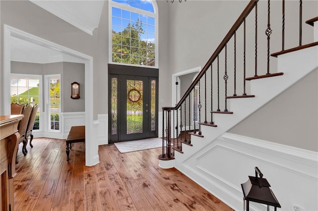 1313 Fallsbrook Ter NW, Acworth, GA 30101 - foyer with wood-type flooring, stairs, wainscoting, plenty of natural light, and ornamental molding