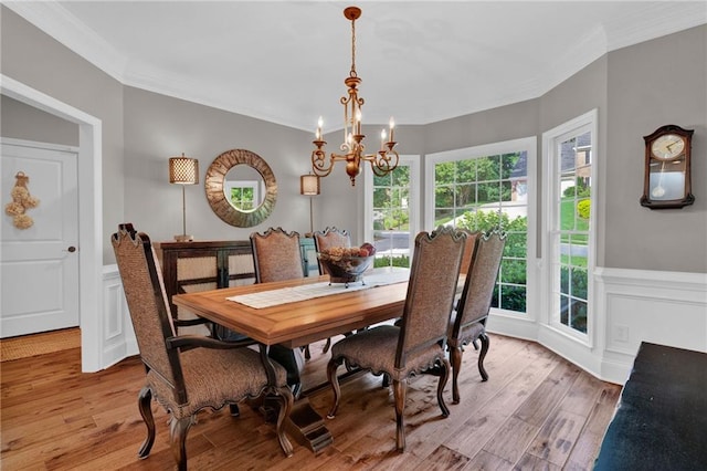 1313 Fallsbrook Ter NW, Acworth, GA 30101 - dining space with ornamental molding, a chandelier, light wood-style flooring, wainscoting, and a decorative wall
