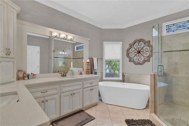 1313 Fallsbrook Ter NW, Acworth, GA 30101 - bathroom featuring double vanity, a shower stall, a soaking tub, tile patterned floors, and crown molding