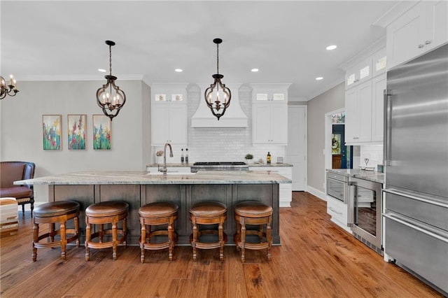 1313 Fallsbrook Ter NW, Acworth, GA 30101 - kitchen featuring built in refrigerator, a chandelier, wine cooler, tasteful backsplash, and crown molding