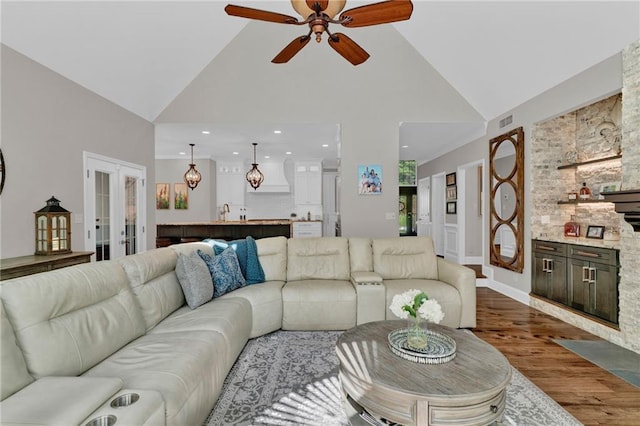 1313 Fallsbrook Ter NW, Acworth, GA 30101 - living room with a ceiling fan, dark wood-style floors, high vaulted ceiling, recessed lighting, and french doors