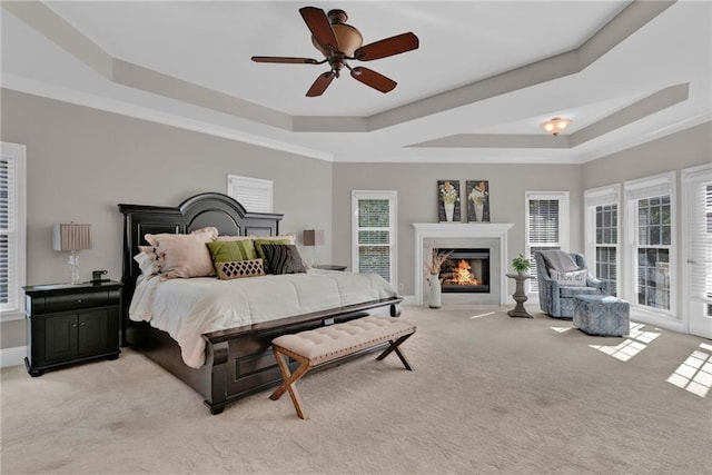 1313 Fallsbrook Ter NW, Acworth, GA 30101 - bedroom featuring a raised ceiling, light colored carpet, a fireplace, and a ceiling fan