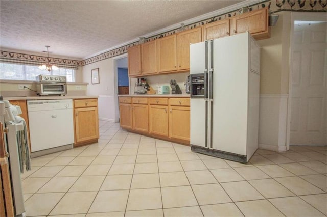 kitchen with white appliances, a textured ceiling, light tile patterned flooring, and hanging light fixtures