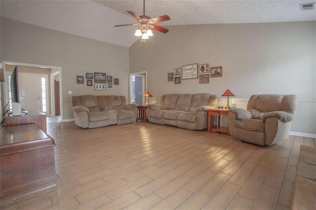 living room featuring high vaulted ceiling, light wood-type flooring, a textured ceiling, and ceiling fan