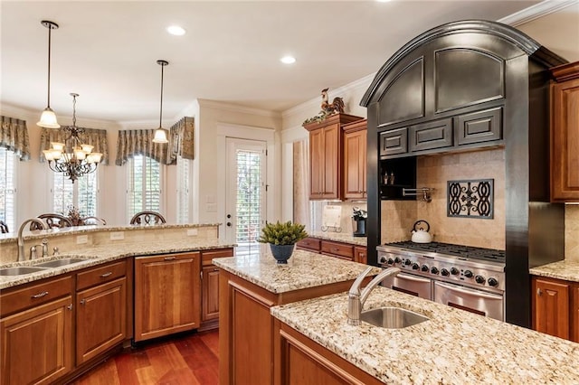 kitchen featuring sink, ornamental molding, light stone countertops, and range with two ovens