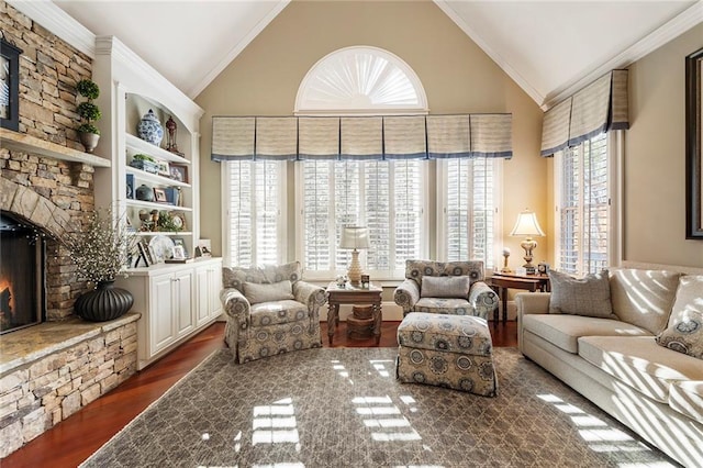 living area featuring dark hardwood / wood-style floors, ornamental molding, a fireplace, and built in features