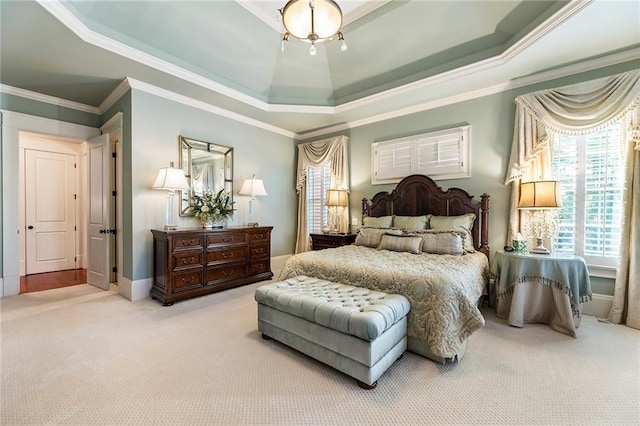 bedroom with crown molding, a tray ceiling, and light carpet