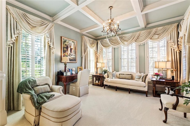 sitting room with beam ceiling, carpet floors, a healthy amount of sunlight, and an inviting chandelier