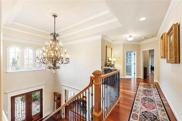 hall with french doors, ornamental molding, dark hardwood / wood-style flooring, and a tray ceiling