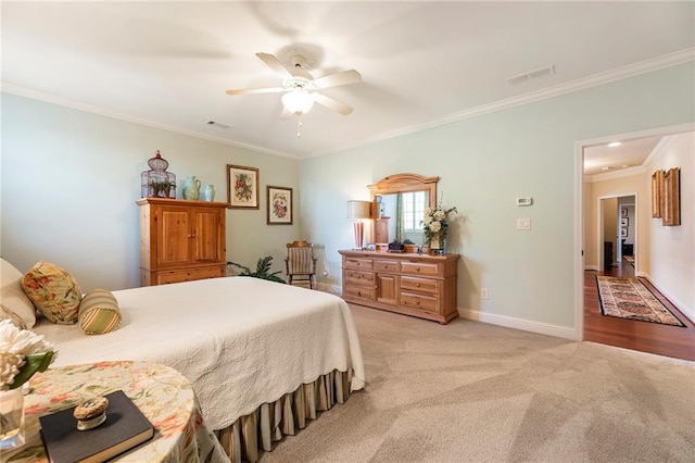 carpeted bedroom with crown molding and ceiling fan