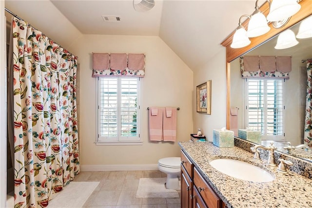 bathroom with vanity, a wealth of natural light, lofted ceiling, and toilet